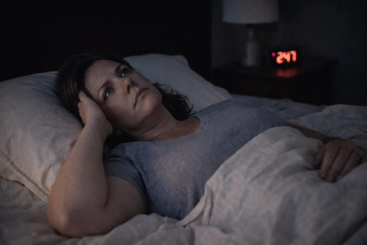 woman awake at 2am with sleep problems caused by insulin resistance